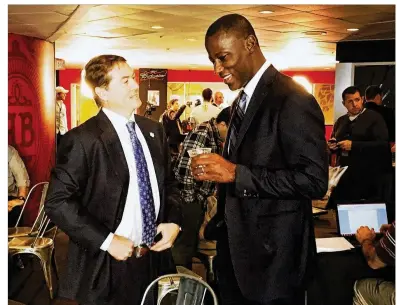  ?? DAVID JABLONSKI / STAFF ?? Saint Louis coach Travis Ford (left) chats with Dayton coach Anthony Grant at Atlantic 10 Media Day on Tuesday at the Capital One Center in Washington. Saint Louis ranked seventh in the 2017-18 Atlantic 10 preseason poll.