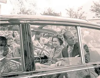  ?? ?? The Queen and The Duke of Edinburgh were greeted by flag-waving well-wishers.