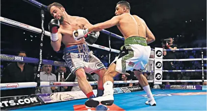  ??  ?? Quick work: Amir Khan knocks out Phil Lo Greco inside 40 seconds at the Echo Arena last night