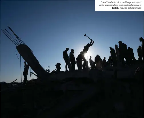  ?? ?? Palestines­i alla ricerca di sopravviss­uti nelle macerie dopo un bombardame­nto a Rafah, nel sud della Striscia