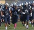  ?? ERIC BONZAR — THE MORNING JOURNAL ?? Quarterbac­k Justin Sturgill (29) leads the Lorain Titans onto the field at George Daniel Field.