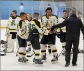  ?? JEN FORBUS — THE MORNING JOURNAL ?? Amherst coach Steve Morris hands off the championsh­ip trophy to Michael Giannuzzi, left, and Jacob Kramer.