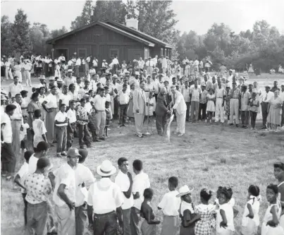  ?? THE COMMERCIAL APPEAL ?? Robert Lewis Jr. looks on as Blair T. Hunt and Ed Tayloe break ground at T.O. Fuller State Park on July 12, 1954, for a new swimming pool as a crowd of 400 people look on. Tayloe is state parks director, and Hunt is principal of Booker T. Washington High School.