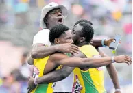  ?? GLADSTONE TAYLOR/MULTIMEDIA PHOTO EDITOR ?? Bert Cameron celebrates with St Jago’s Class 1 Boys team moments after they won the 4x100 metres at the Gibson McCook Relays held at the National Stadium yesterday.