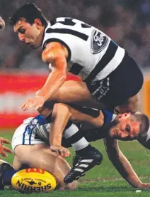  ??  ?? CONTEST: Peter Riccardi sits on back of ex-teammate Robert Scott in the 1997 qualifying final at the MCG.