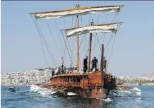  ?? THANASSIS S TAV R A K I S / THE ASSOCIATED PRESS ?? Visitors to Greece can row the Olympias, a reconstruc­tion of an ancient warship called a trireme.