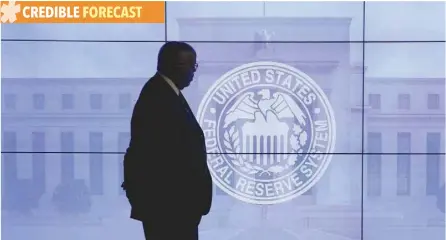  ?? — Reuters ?? A guard walks in front of a Federal Reserve image before press conference in Washington.