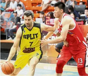  ??  ?? Excuse me!: KK Split’s Mateo Kedzo trying to dribble past Guangzhou Securities Long Lions’ Fan Zi Ming in the Seri Mutiara Cup Group A game at the Maba Stadium yesterday — M. AZHAR ARIF / The Star