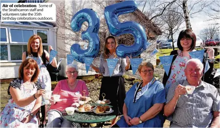  ??  ?? Air of celebratio­n Some of the Strathcarr­on staff and volunteers take the 35th birthday celebratio­ns outdoors.