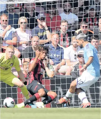 ?? EPA ?? SERGIO AGUERO scores Manchester City’s opener against Bournemout­h in the Premier League yesterday.
|