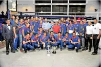  ??  ?? MAS Slimline men’s champion of the Clifford Cup boxing meet posing for a picture with the officials after receiving the trophy.