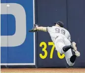  ?? CHRIS O'MEARA/ASSOCIATED PRESS ?? Yankees right fielder Aaron Judge makes a diving catch on a drive by the Rays' Evan Longoria during the 6th inning.