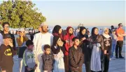  ?? (V K Shafeer/Muscat Daily) ?? People watch the eclipse at Seeb Corniche