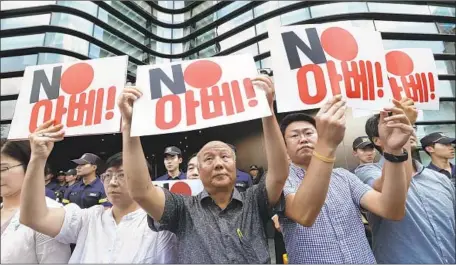  ?? Ahn Young-joon Associated Press ?? SOUTH KOREANS protest outside the Japanese Embassy in Seoul against Tokyo’s decision to revoke South Korea’s “whitelist” status.