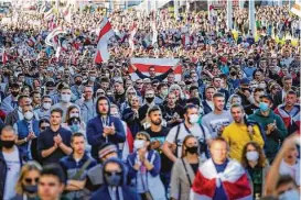  ?? Associated Press ?? Protesters with old Belarusian national flags march during an opposition rally against official presidenti­al election results in Minsk on Sunday.