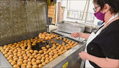  ?? Lori Van Buren / Times Union archive ?? At last year’s annual Greek Fest at St. Sophia’s Greek Orthodox Church, Maria Xythalis scoops out Loukoumade­s, Greek fried dough balls, from a deep fryer. This year’s event will be noon to 10 p.m. Saturday and noon to 6 p.m. Sunday.