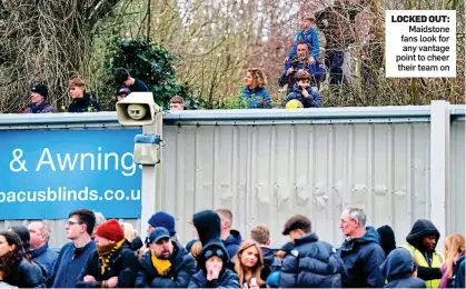  ?? ?? LOCKED OUT: Maidstone fans look for any vantage point to cheer their team on