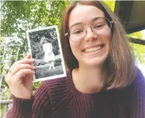  ?? ABBEY FERREIRA/THE CANADIAN PRESS ?? Abbey Ferreira, a nursing student who recently completed her first year online at the University of Calgary, holds a 1948 photo of her grandmothe­r as a nursing student.