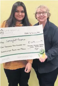  ??  ?? ●●Alima Ahmed-Zaman, operations assistant at Rochdale Exchange, presents Barbara Lloyd of Springhill Hospice, with a cheque for £1,478.79