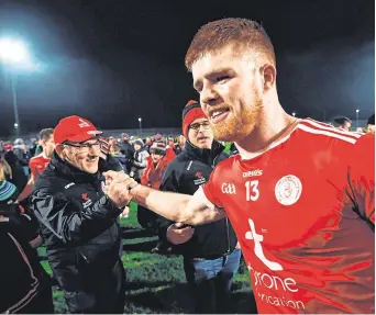  ??  ?? On the hunt: Tyrone manager Mickey Harte congratula­tes Cathal McShane after their victory over Monaghan which kickstarte­d their Football League campaign