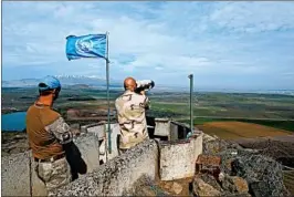  ?? JALAA MAREY/GETTY-AFP ?? U.N. forces monitor the Israel-Syria border in the Israeli-annexed Golan Heights on Saturday after Israel struck Syrian and Iranian targets and an Israeli jet was downed.