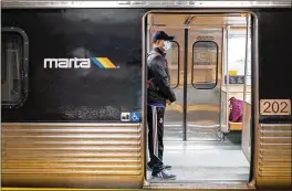  ?? BEN GRAY / FOR THE AJC ?? MARTA is seeing an uptick of individual­s seeking refuge in rail stations and riding trains with no specific destinatio­n. Wary of COVID-19, customers have complained that this scenario makes them feel uneasy and unsafe.