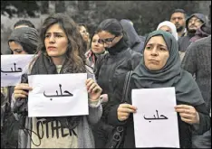  ?? BILAL HUSSEIN / AP ?? Syrian and Lebanese activists, holding papers reading “Aleppo,” hold a sit-in Tuesday in Beirut to express solidarity with residents of the Syrian city.