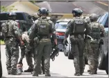  ?? Mark Mulligan / Houston Chronicle ?? Police and FBI carry tools toward a home believed to be related to the fatal school shooting earlier in the day at Santa Fe High School on Friday in Santa Fe, Texas.