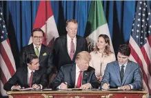  ?? SARAH PABST BLOOMBERG ?? Mexican President Enrique Pena Nieto, U.S. President Donald Trump and Canadian Prime Minister Justin Trudeau sign the new trade agreement.