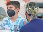  ?? MARTA LAVANDIER/AP ?? Andres Veloso, 12, gets the first dose of the Pfizer COVID-19 vaccine on Monday in Miami. Florida is reporting a surge in cases.