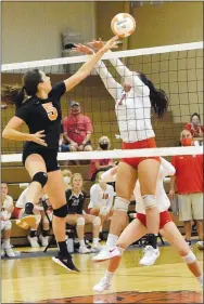  ?? Westside Eagle Observer/MIKE ECKELS ?? Lady Lion Lauren Irwin (5) tips the ball away from a Lady Cardinal player during the Aug. 25 Gravette-Farmington varsity match in Gravette. Irwin’s shot dropped between two Farmington players for a Gravette point.