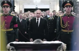  ?? AFP ?? Russian president Vladimir Putin pays respects to Andrei Karlov, the slain ambassador to Turkey.