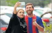  ?? AFP ?? Reza Parastesh, a doppelgang­er of football superstar Lionel Messi, poses for a picture with a fan in Tehran on Monday.