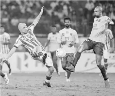  ??  ?? This file photo taken on Dec 18, 2016 shows Kerala Blasters FC midfielder Azrack Mahamat (right) fighting for the ball with Atletico de Kolkata forward Iain Edward Hume during the final Indian Super League (ISL) football match at the Jawahar Lal Nehru...