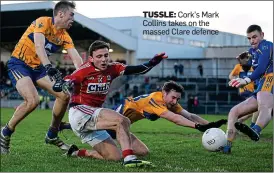  ??  ?? TUSSLE: Cork’s Mark Collins takes on the massed Clare defence