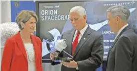  ??  ?? FLORIDA, United States: US Vice Pesident Mike Pence (center) inspects an Orion spacecraft model as Kennedy Space Center Deputy Director Janet Petro (left) and Kennedy Space Center Director Robert Cabana (right) watch during a tour of the Operations and...