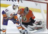  ?? FRED CHARTRAND/THE ASSOCIATED PRESS ?? Senators goalie Craig Anderson stops a shot by Islanders left wing Anders Lee in the third period of Ottawa’s 3-0 win Saturday at Canadian Tire Centre. Anderson had 33 saves in his first start in 69 days.
