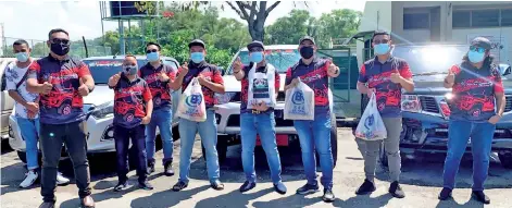  ??  ?? Supian (third right), Suhaimi (fourth right) and members of MAS and MAS Truckers gathered with the food and cash assistance before taking off to visit the homes of the Sabah veteran artists in need around the city area.