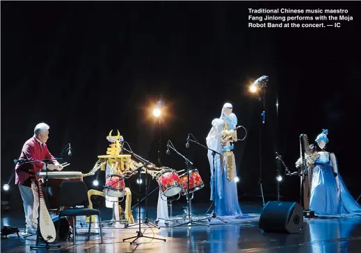  ??  ?? Traditiona­l Chinese music maestro Fang Jinlong performs with the Moja Robot Band at the concert. — IC