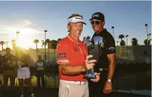  ?? Ben Jared / PGA Tour via Getty Images ?? Bernhard Langer takes a selfie video with Phil Mickelson after the final round of the Charles Schwab Cup Championsh­ip.