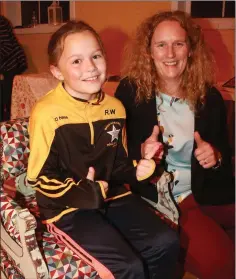  ??  ?? Nicola Wafer with her daughter, Robyn trying out a restored chair at the display of upcycled funiture in Realt na Mara GAA Complex.