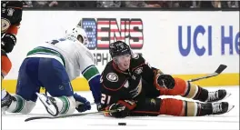  ?? MARK J. TERRILL — THE ASSOCIATED PRESS ?? Ducks center Isac Lundestrom, right, and Vancouver Canucks right wing Brock Boeser fall after colliding in the third period of Vancouver’s 2-1victory Sunday.