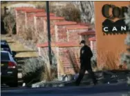  ?? THE ASSOCIATED PRESS ?? An investigat­or heads to the scene of a shooting Sunday in Highlands Ranch, Colo. Authoritie­s in Colorado say one deputy has died and multiple others were wounded, along with two civilians, in a shooting that followed a domestic disturbanc­e in suburban...