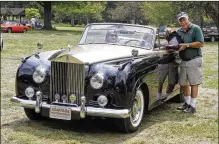  ?? PHOTO BY RON PARKS, COURTESY OF BRITISH CAR DAY DAYTON ?? Peter Stroble, right, president of the British Transporta­tion Museum, presents the Best of Show trophy to Charles Marshall II at British Car Day Dayton on Aug. 7 at Eastwood Metro Park. Marshall’s very rare 1957 Rolls-royce Silver Shadow bested 292 other British cars at the 36th annual event presented by the MG Car Club and Miami Valley Triumphs.