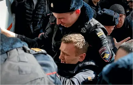  ?? PHOTO: REUTERS ?? Police officers detain anti-corruption campaigner and opposition figure Alexei Navalny during a rally in Moscow.