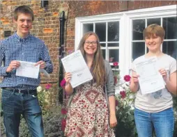  ??  ?? Ashford School pupils Toby Clifton, Lizzy Aviss and Lydia Mullan celebrate their results