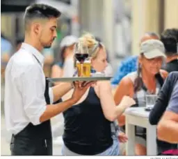  ?? JAVIER ALBIÑANA ?? Un camarero trabaja en un restaurant­e de Málaga.