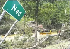  ?? TIMOTHY D. EASLEY/AP PHOTO ?? A Perry County school bus lies destroyed after being caught up in the floodwater­s of Lost Cree in Ned, Ky.