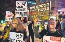  ?? AFP ?? Demonstrat­ors gather with signs during a protest against the war and the planned operation in Rafah, outside the Kirya military base in Tel Aviv, Israel on Tuesday.