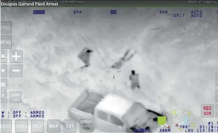  ??  ?? A screen shot of court-supplied infrared video shows the capture of Douglas Garland on a farm near Airdrie by Calgary Police as he emerged from a thick group of trees. He is now on trial for the murder of three people.